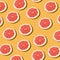 Pink ripe grapefruit slices on the orange background pattern