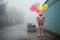 Pink robot with colorful balloons on the street in a foggy day. Generative AI