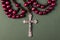 Pink Rosary on a green background.