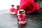 Pink rose flower and glass of bottle essential oil. spa and aromatherapy cosmetic concept