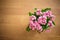 Pink rose on wooden background