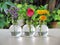 Pink rose, yellow chrysanthemum and Purple Margaret flower in bottles vases