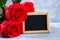 Pink roses with a blank chalkboard for text. Copy space for text. Template for March 8, Mother\'s Day, Valentine\'s Day.