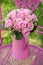 Pink roses bouquet in a little watering can