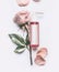 Pink Roses essential cosmetic product bottle with branding mock up and rose flowers