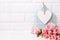 Pink roses flowers and, decorative bird cage and white heart ag