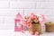 Pink roses flowers and decorative pinke lantern against white b