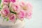 Pink roses in a shabby chic metal bucket