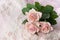 Pink roses on wedding lace (copy space)