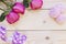 Pink roses on wooden background