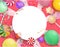 Pink round festive background with colorful sweets.