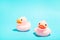 Pink rubber ducks organized on blue background