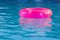 Pink rubber ring in the swimming pool