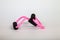 Pink rubber tube expander with black paralon handles for performing fitness exercises with hands