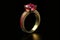 pink ruby engagement ring in yellow gold, on black background