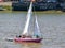 A pink sail boat adorned with environmental messages such as stop ecocide