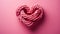 Pink sailor rope rolled into a heart shape on a solid pastel background. Heart-shaped sailor knots.