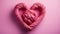 A pink sailor\\\'s rope rolled into a heart shape held by female hands by the sea. Heart-shaped sailor knots.