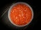 Pink salmon caviar in plastic container.