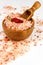 Pink salt from the Himalayas on white background. Pile of pink Himalayan salt. Salt and chilli peppers. Sale of spices