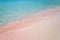 Pink sand and turquoise pristine water one Balos beach in Crete, Greece