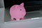 .Pink saving pig on the notebook.Concept of saving money, make a deposit.Money in save