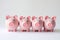 Pink Savings: Adorable Piggy Bank on a Rosy Background