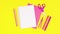 Pink school stationery appear on yellow background. Stop motion