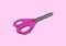 Pink scissors on pink background