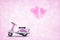 Pink scooter toy with pink heart love balloon on light pink hear