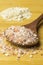 Pink sea salt on a wooden spoon and oatmeal