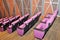 Pink seat row in modern auditorium decoration with wooden wall and floor.