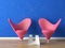 Pink seats on blue wall