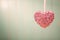 Pink shiny heart on vintage green wood background