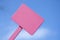 Pink Sign on Bright Blue Cloudy Sky