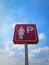 Pink Sign of Reserved Parking Area for Ladies Against Cloudy Sky