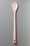 Pink silicone spoon on grey, from above