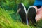 Pink sneakers on girl legs on grass