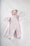 Pink snowsuit baby on bed