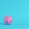 Pink soccer ball on bright blue background in pastel colors