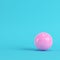 Pink soccer ball on bright blue background in pastel colors