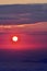 The pink solar disk seen from high altitude at sunrise. alpine sea at the mountain