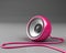 Pink speaker with cable over grey