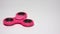 A pink spinner rotates on a white background.