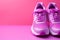 Pink sports sneakers pop against a matching pink background