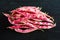 Pink spotty bean pods Phaseolus on a wooden black table