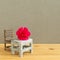 Pink spray carnation flower on school desk with empty chair. Teacher`s day concept