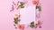 A pink square frame decorated with multicoloured flowers, blank space for text.