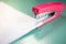 Pink stapler does not pierce through many sheets of paper.shallow focus effect