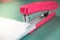 Pink stapler does not pierce through many sheets of paper.shallow focus effect